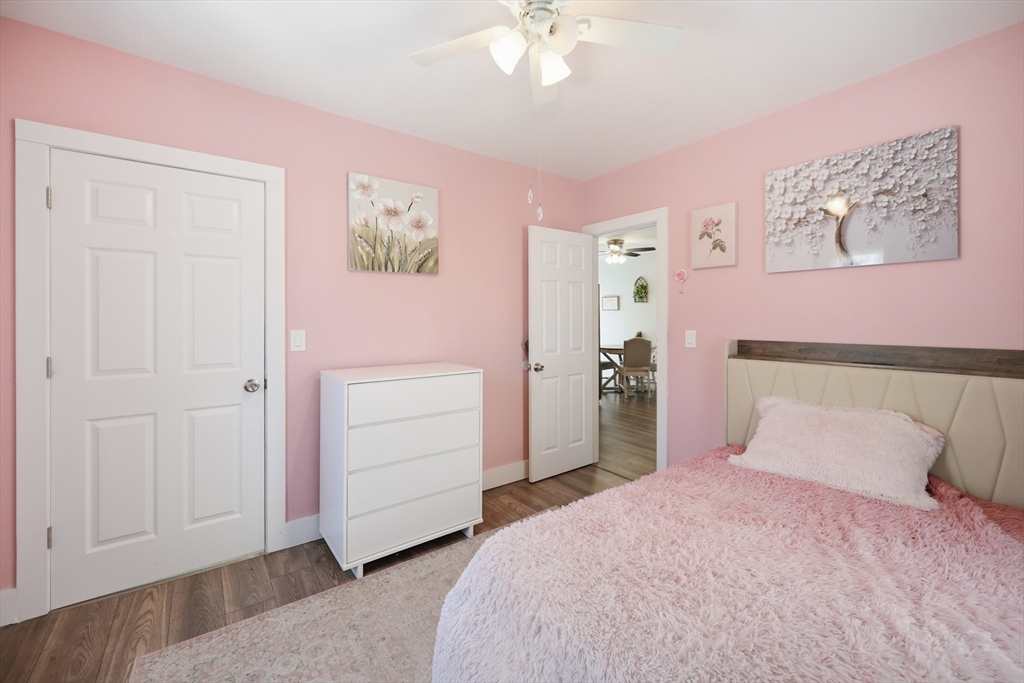 70 Wyman Street Lynn, MA 01905 - Photo 22 of 41 a bedroom with a bed and a chandelier