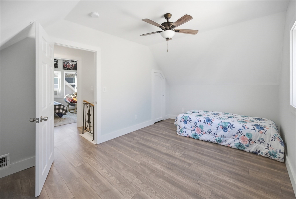 70 Wyman Street Lynn, MA 01905 - Photo 28 of 41 a bedroom with a bed and wooden floor