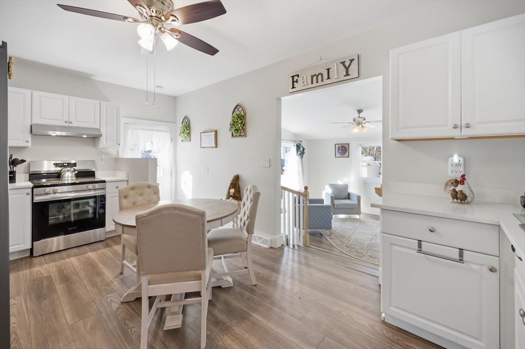 70 Wyman Street Lynn, MA 01905 - Photo 7 of 41 a kitchen with a table chairs refrigerator and cabinets