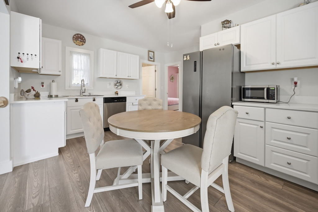 70 Wyman Street Lynn, MA 01905 - Photo 9 of 41 a kitchen with stainless steel appliances a dining table chairs stove refrigerator and cabinets