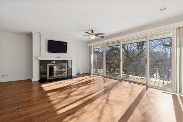 a view of an empty room with a fireplace and a flat screen tv