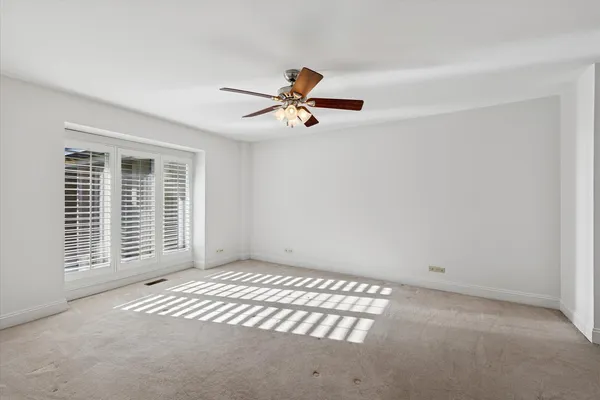 a view of a livingroom with a ceiling fan and window