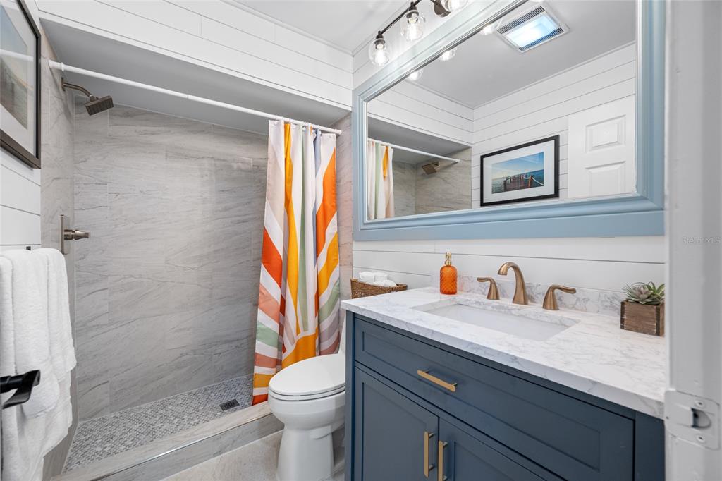 2153 Karan Way Clearwater, FL 33763 - Photo 21 of 65 a bathroom with a sink a toilet and a shower