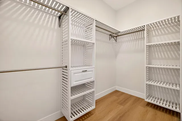 a large bathroom with a double vanity sink large mirror and a bathtub