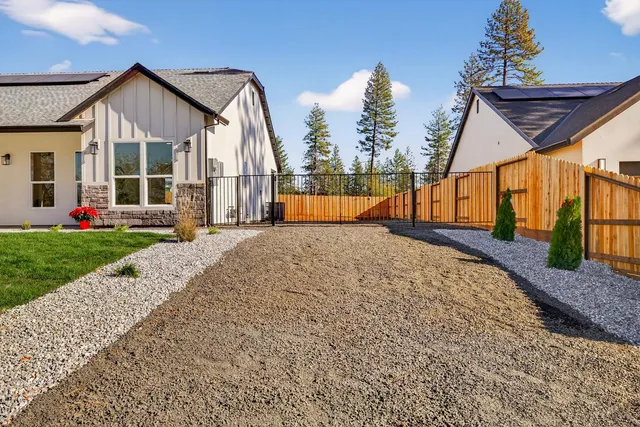 a front view of a house with yard and garage
