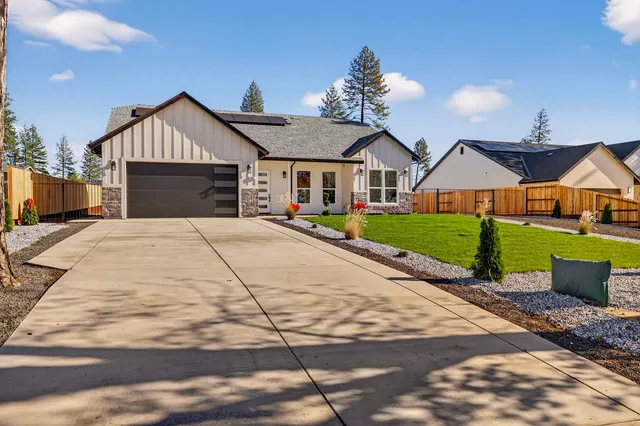 a front view of a house with yard and garage