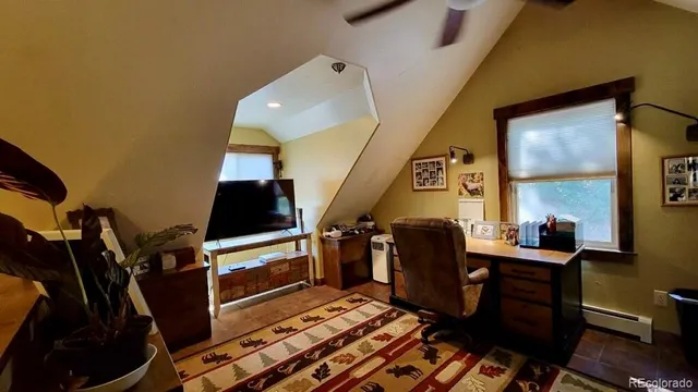 a living room with furniture a ceiling fan and a fireplace