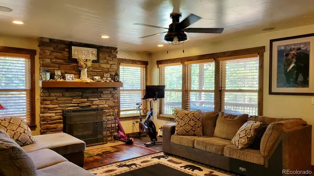a view of a dining room with furniture chandelier and wooden floor