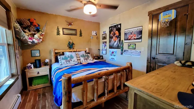 a bedroom with a bed and a lamp on dresser