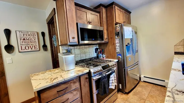 a kitchen with stainless steel appliances a refrigerator a stove and a microwave
