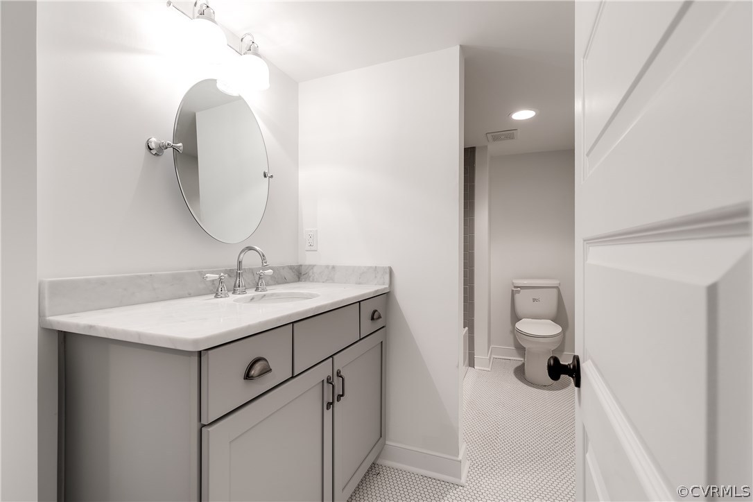 4549 Arrowhead Road Richmond, VA 23235 - Photo 14 of 16 a bathroom with a sink toilet and mirror