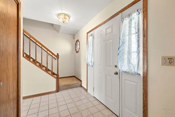 a view of an entryway with wooden floor