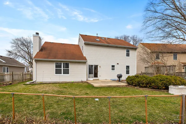 a view of a backyard with large trees