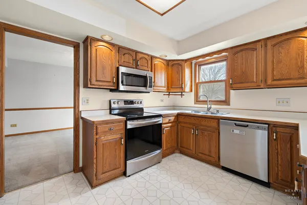 a kitchen with granite countertop a sink and steel appliances