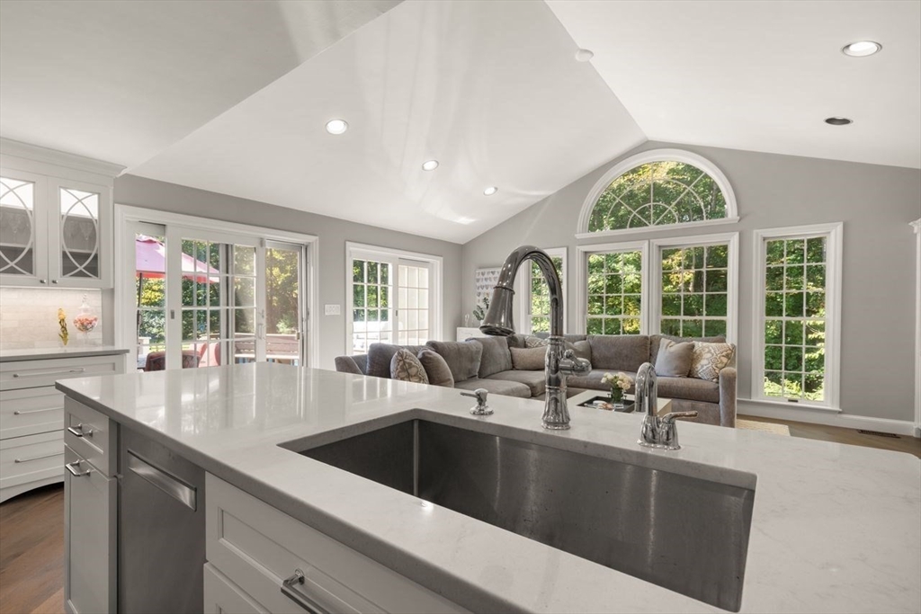 24 Queens Circle Sharon, MA 02067 - Photo 15 of 41 a view of a kitchen with a sink and living room