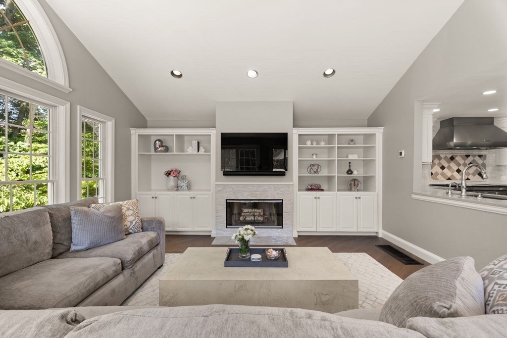 24 Queens Circle Sharon, MA 02067 - Photo 18 of 41 a living room with furniture a flat screen tv and a fireplace