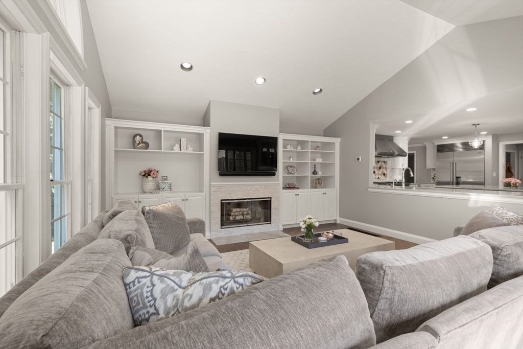 24 Queens Circle Sharon, MA 02067 - Photo 20 of 41 a living room with furniture a fireplace and a flat screen tv