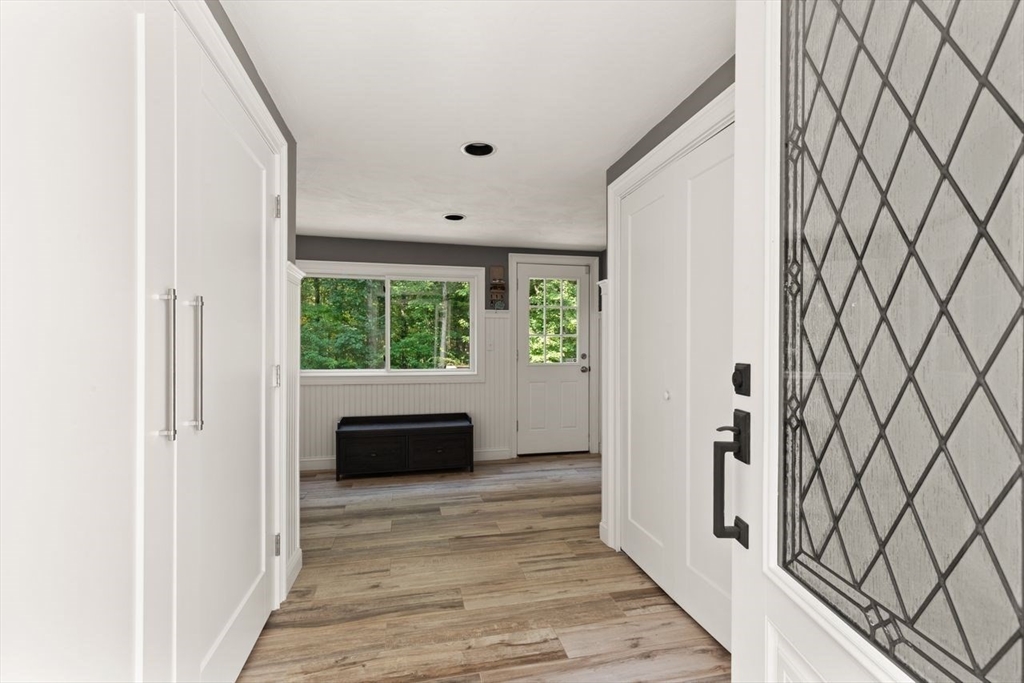 24 Queens Circle Sharon, MA 02067 - Photo 23 of 41 a view of a livingroom with wooden floor and a window