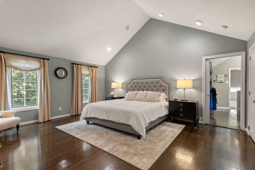 24 Queens Circle Sharon, MA 02067 - Photo 24 of 41 a bedroom with a large bed and wooden floor
