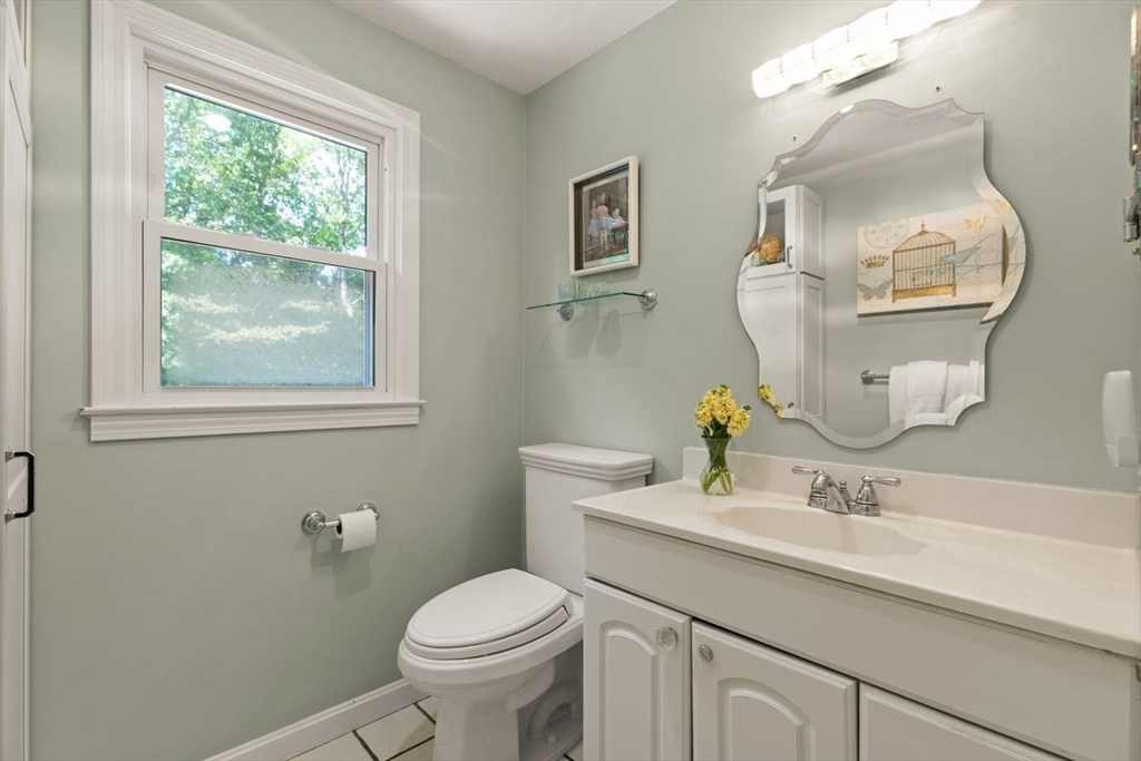 24 Queens Circle Sharon, MA 02067 - Photo 26 of 41 a bathroom with a toilet a sink a vanity and a mirror