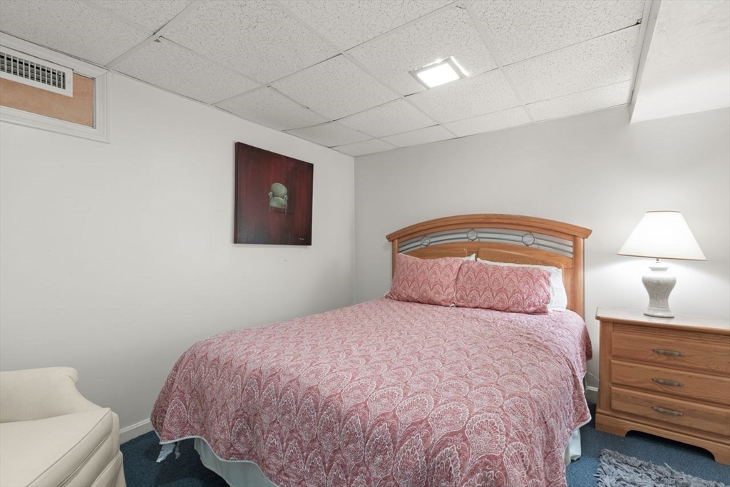 24 Queens Circle Sharon, MA 02067 - Photo 34 of 41 a bedroom with a bed and a lamp