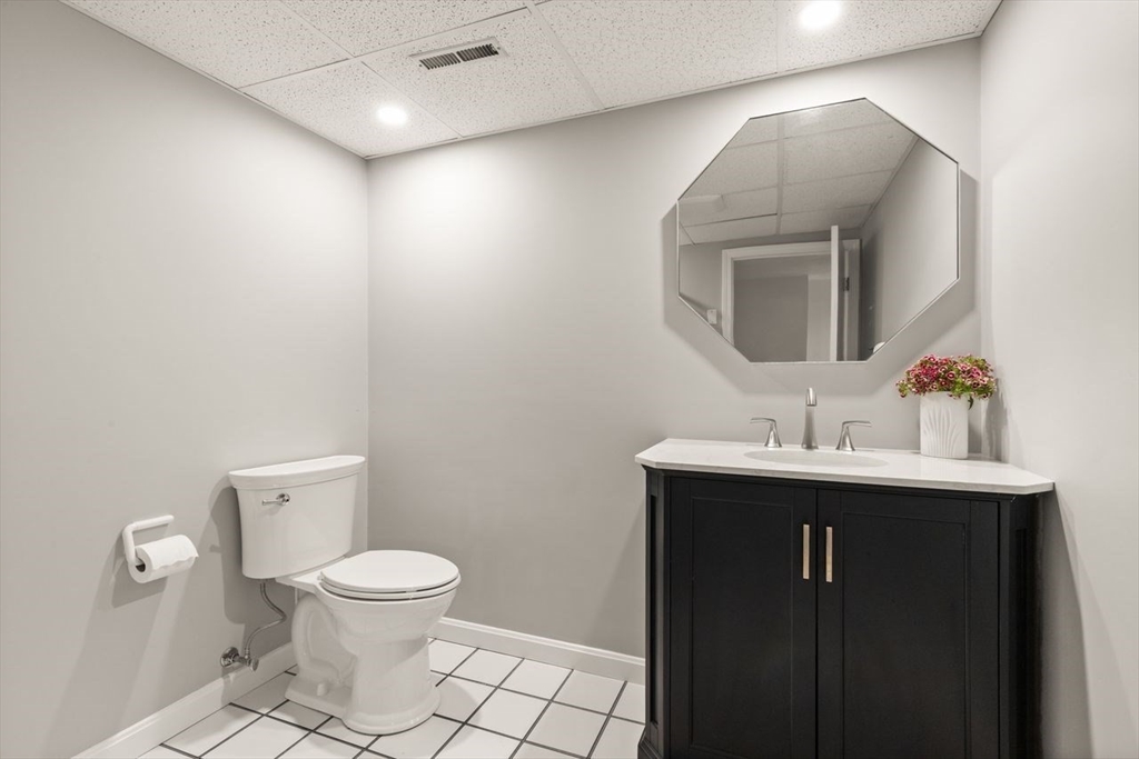 24 Queens Circle Sharon, MA 02067 - Photo 35 of 41 a bathroom with a toilet sink and mirror