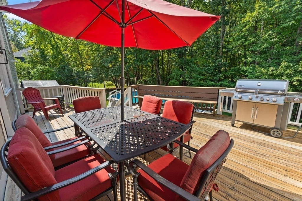 24 Queens Circle Sharon, MA 02067 - Photo 36 of 41 an outdoor sitting area with furniture and umbrella