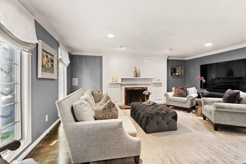 24 Queens Circle Sharon, MA 02067 - Photo 5 of 41 a living room with furniture a fireplace and a flat screen tv