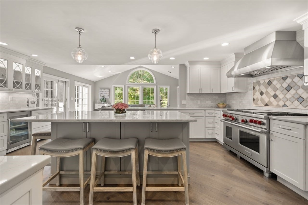 24 Queens Circle Sharon, MA 02067 - Photo 10 of 41 a kitchen with a dining table chairs stainless steel appliances and cabinets