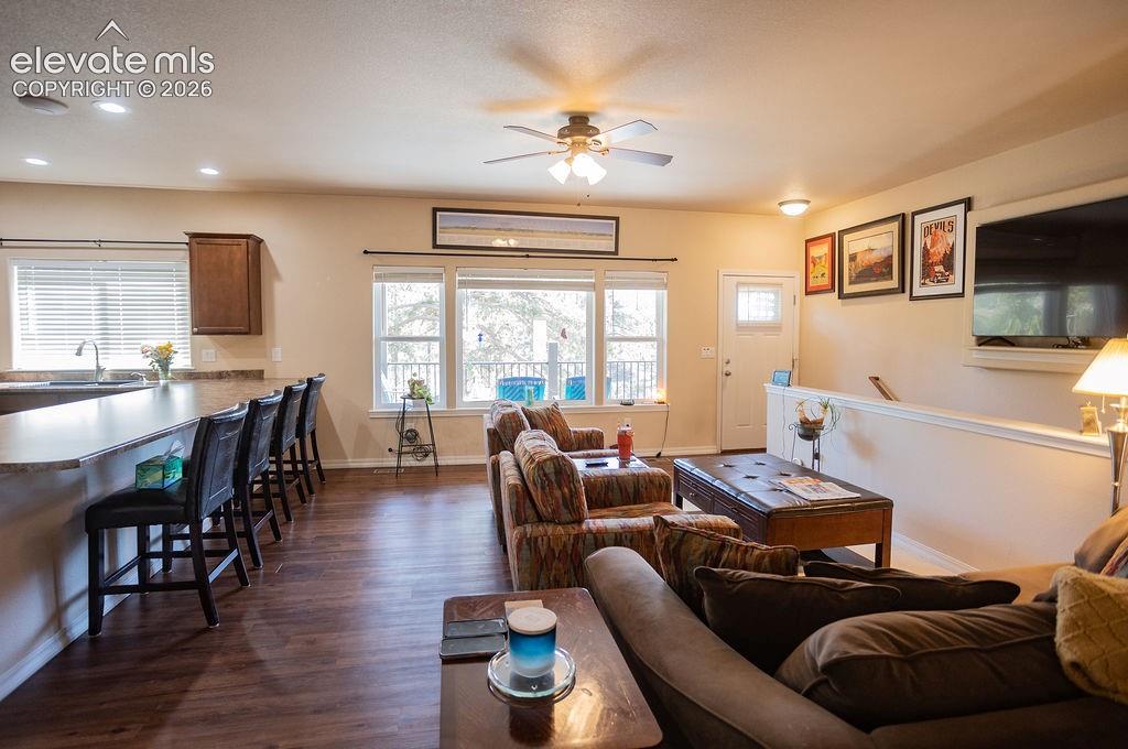 45 Valley Circle Divide, CO 80814 - Photo 5 of 42 a living room with furniture a flat screen tv and wooden floor
