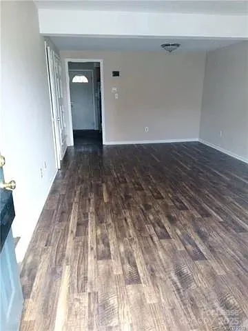 a view of a room with wooden floor