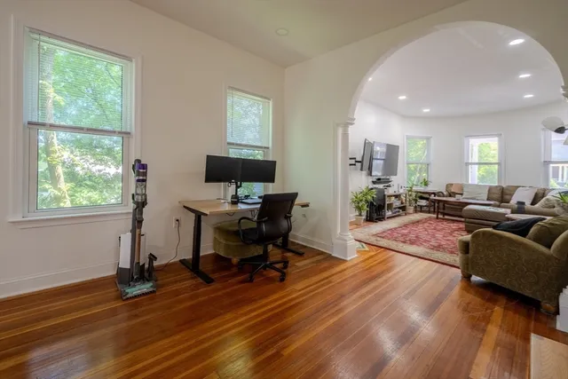 a view of a livingroom with workspace and a window