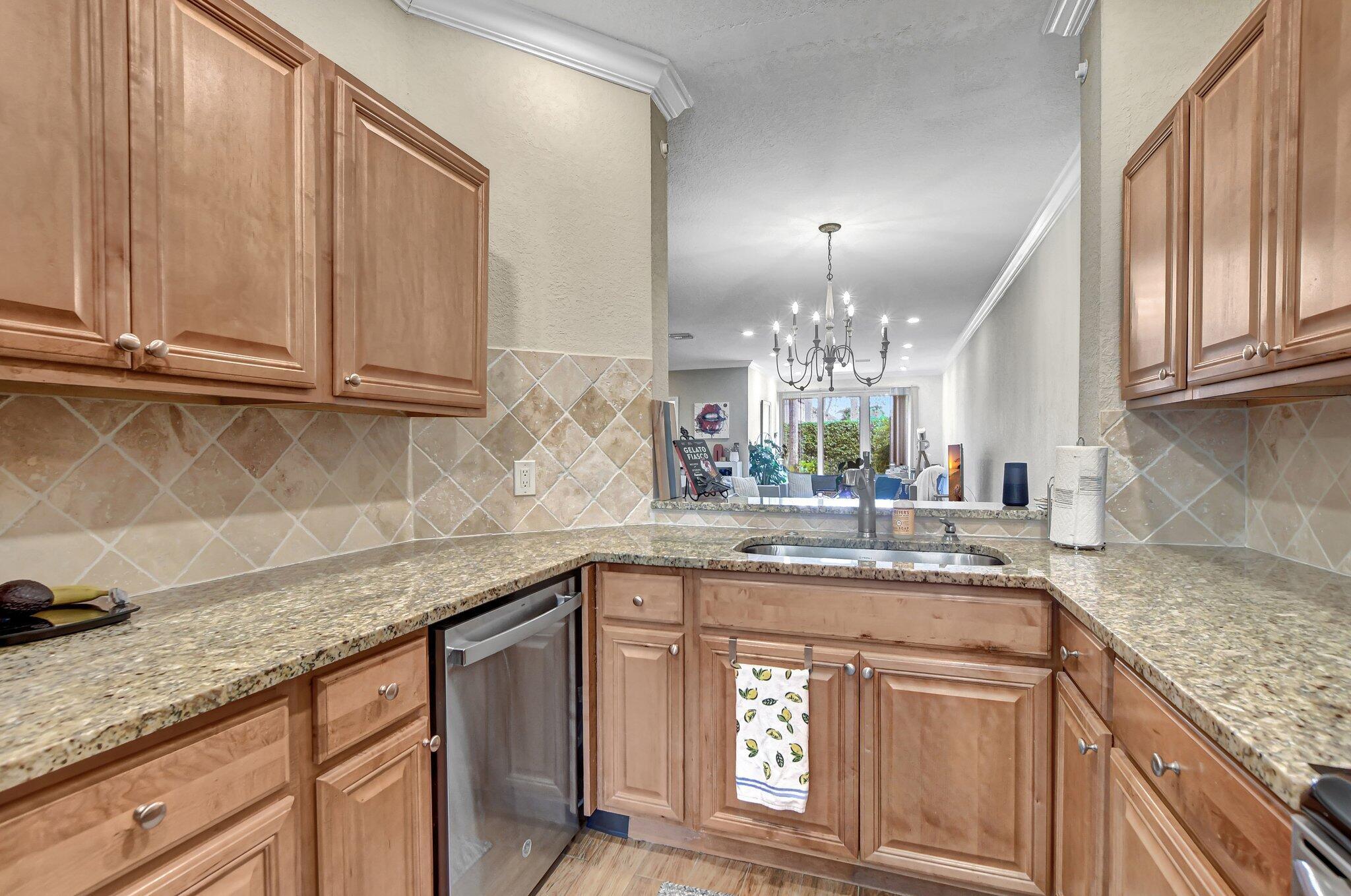 6682 Via Regina Boca Raton, FL 33433 - Photo 6 of 46 a kitchen with granite countertop stainless steel appliances sink and cabinets