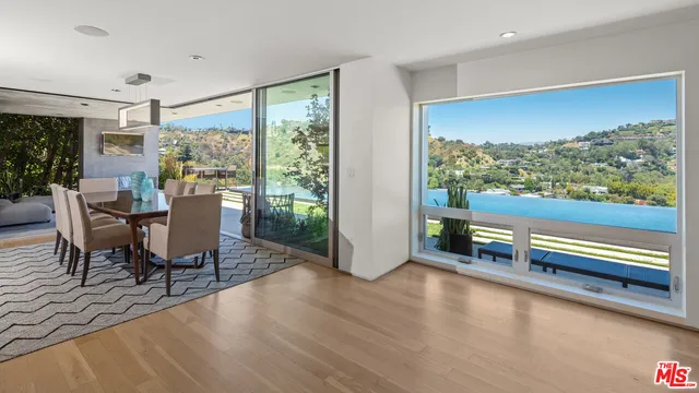 a view of a dining room with furniture and a floor to ceiling window