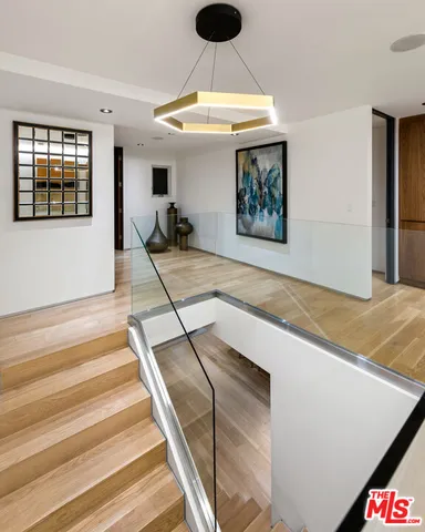 a view of a living room hardwood floor and kitchen