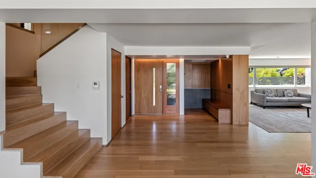 a kitchen with stainless steel appliances granite countertop a sink a stove and a wooden floors