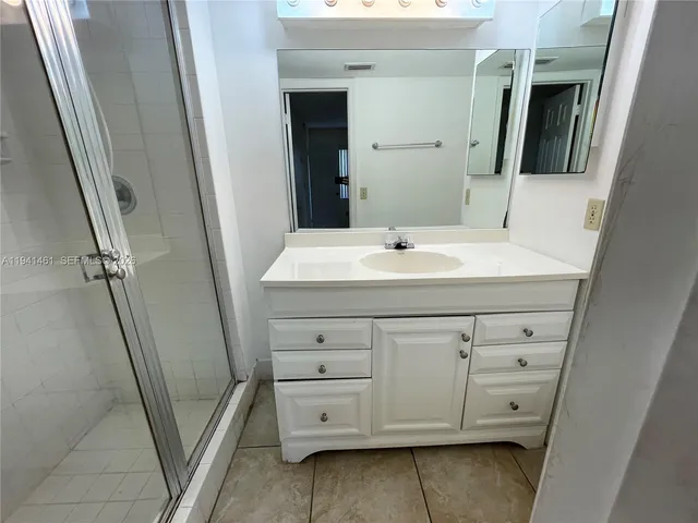 a bathroom with a sink a mirror a vanity and a window
