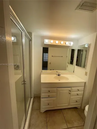 a bathroom with a double vanity sink and mirror