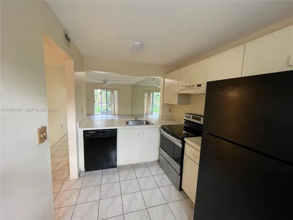 a kitchen with a refrigerator and a sink