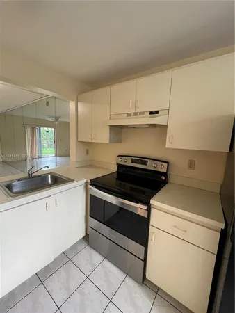 a kitchen with granite countertop cabinets and white appliances