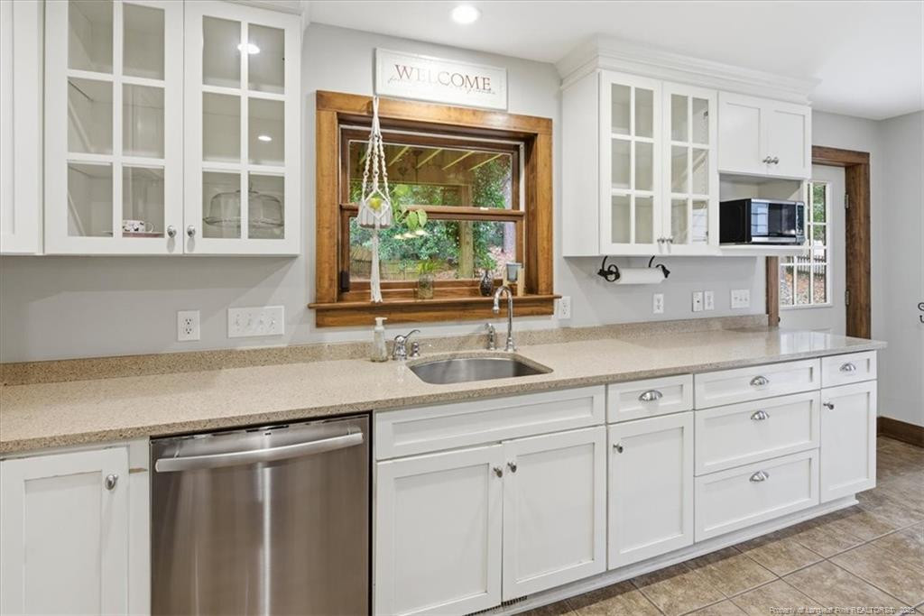 575 South Valley Road Southern Pines, NC 28387 - Photo 12 of 48 a kitchen with stainless steel appliances white cabinets and a window