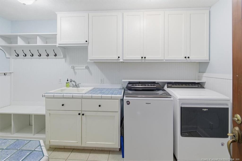 575 South Valley Road Southern Pines, NC 28387 - Photo 17 of 48 a utility room with cabinets washer and dryer