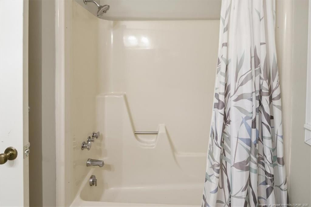 575 South Valley Road Southern Pines, NC 28387 - Photo 30 of 48 a bathroom with a shower curtain and a bathtub