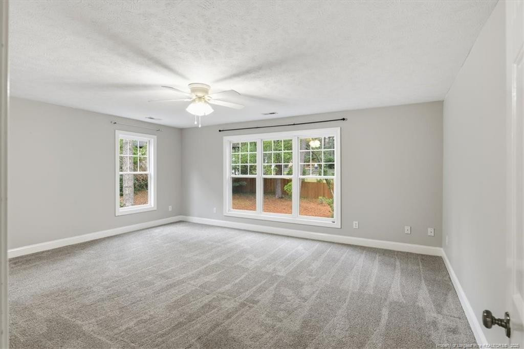 575 South Valley Road Southern Pines, NC 28387 - Photo 39 of 48 an empty room with chandelier fan and windows