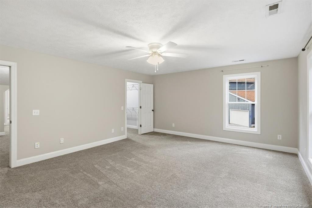 575 South Valley Road Southern Pines, NC 28387 - Photo 40 of 48 an empty room with chandelier fan and windows