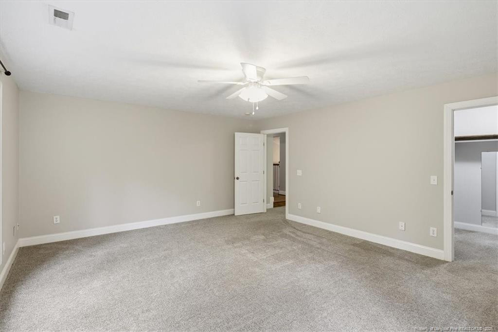 575 South Valley Road Southern Pines, NC 28387 - Photo 41 of 48 an empty room with a ceiling fan and a fan