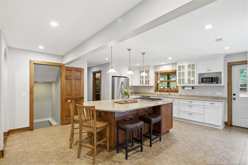 575 South Valley Road Southern Pines, NC 28387 - Photo 9 of 48 a large kitchen with cabinets chairs and counter space