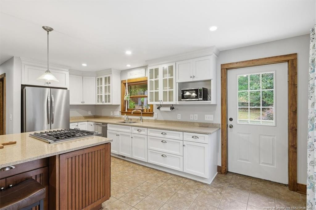 575 South Valley Road Southern Pines, NC 28387 - Photo 10 of 48 a kitchen that has a lot of cabinets in it and wooden floors