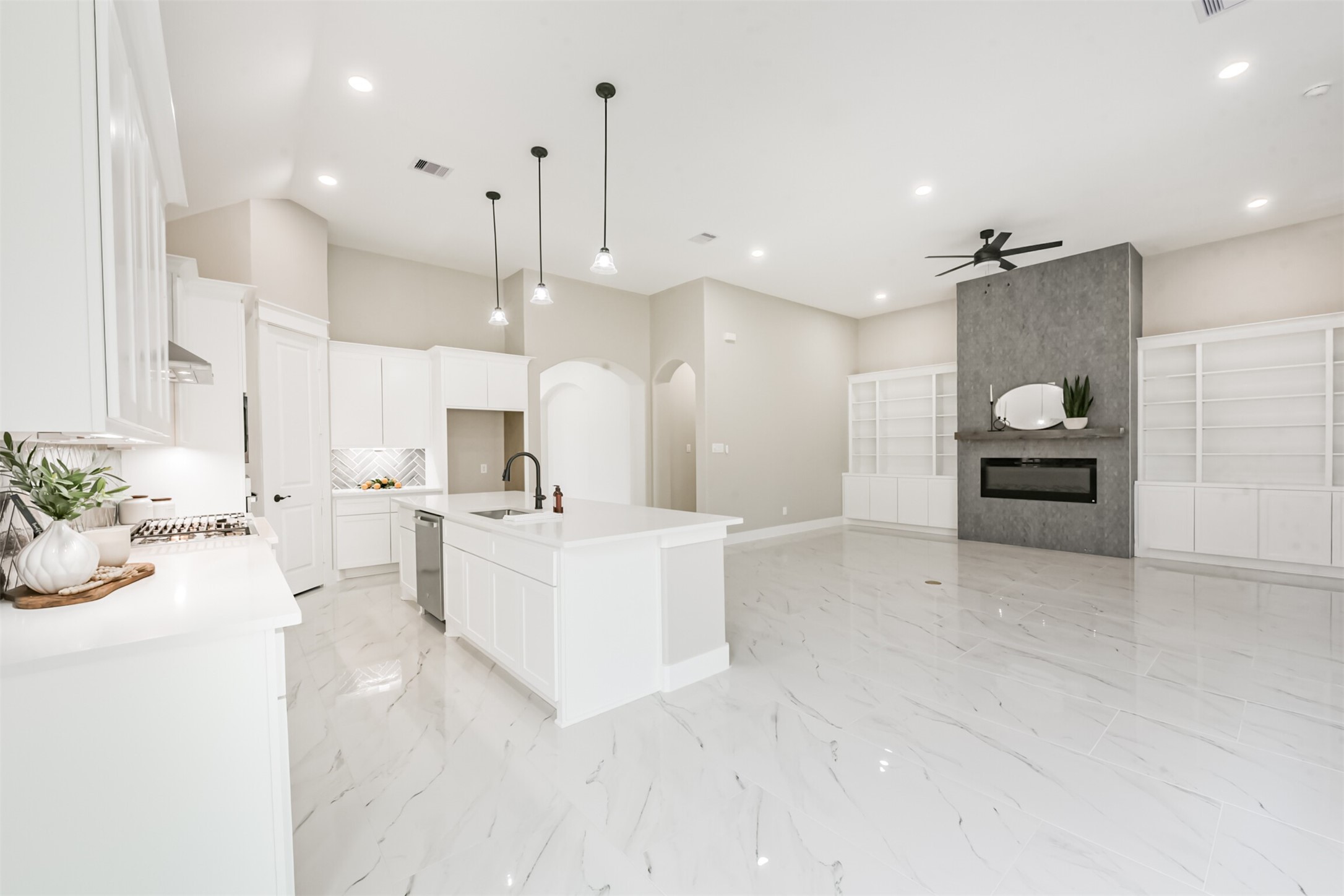 2803 Lancaster Lane Pasadena, TX 77506 - Photo 14 of 45 a large white kitchen with a large white kitchen island a sink dishwasher and a stove with white countertops