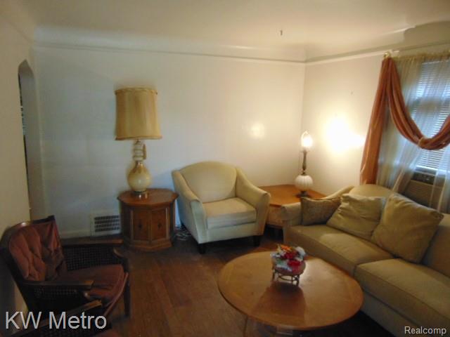 20495 Meyers Road Detroit, MI 48235 - Photo 2 of 7 Living area featuring wood finished floors, cooling unit, and arched walkways